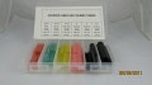 Load image into Gallery viewer, A small plastic organizer tray holding multiple colored pencils or markers, with a white card showing numbers above them. The product is photographed on a plain white background.
